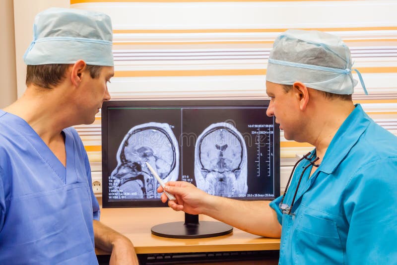 Young head injured woman visiting young male doctor, stock photo