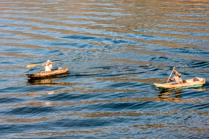 Two men in dugout canoes on Lake Atitlan, Guatemala royalty free stock image Two men in dugout canoes on Lake Atitlan, Guatemala royalty free stock image