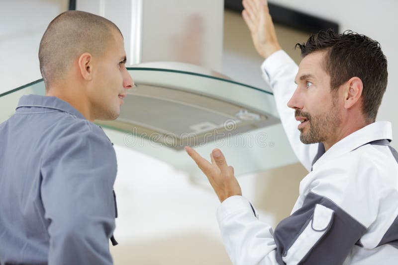 Two Men Installing Modern Kitchen Exhaust Stock Image Image of design