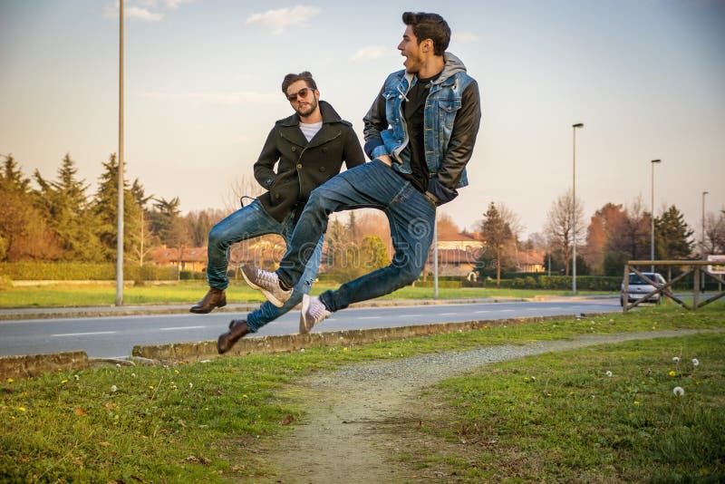 Two Men Leaping in Unison with Hands in Pockets