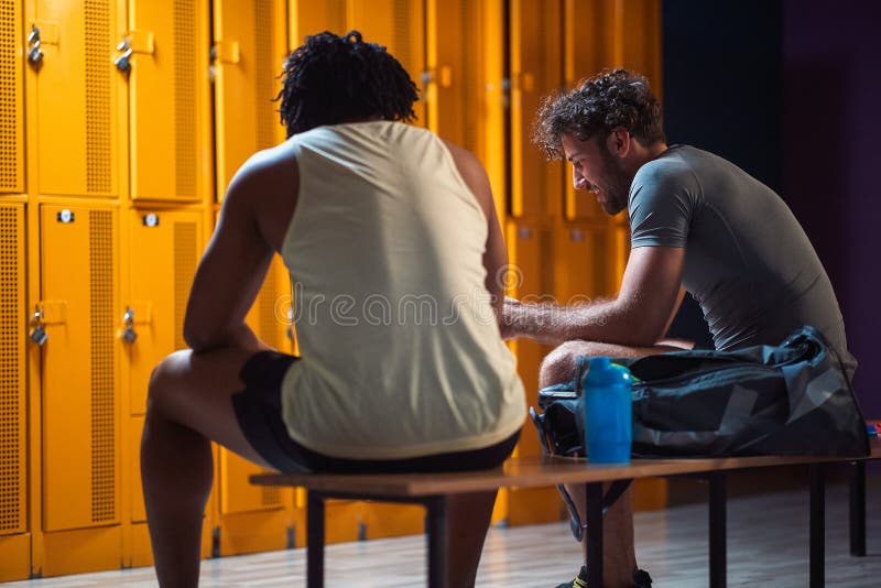 Two Men in the Locker Room Having a Conversation after Workout