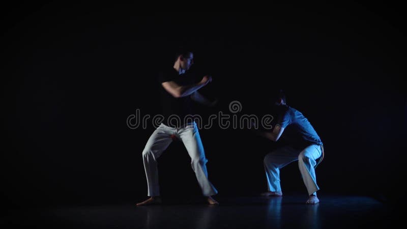 Two Men are Performing Complex of Martial Art of Capoeira Slow Motion Two Men are Performing Complex of Martial Art of Capoeira Slow Motion