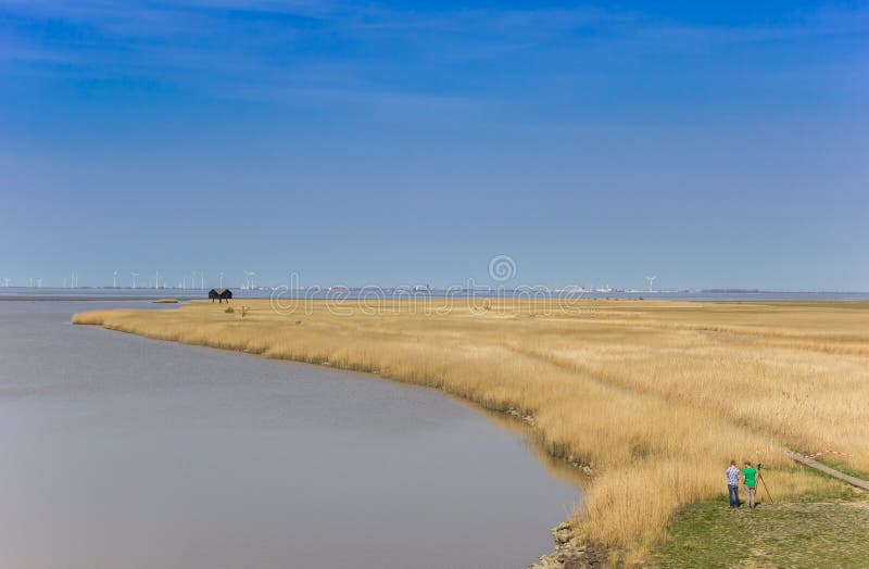 Two men taking images of the bird watching hut in Groningen, Netherlands