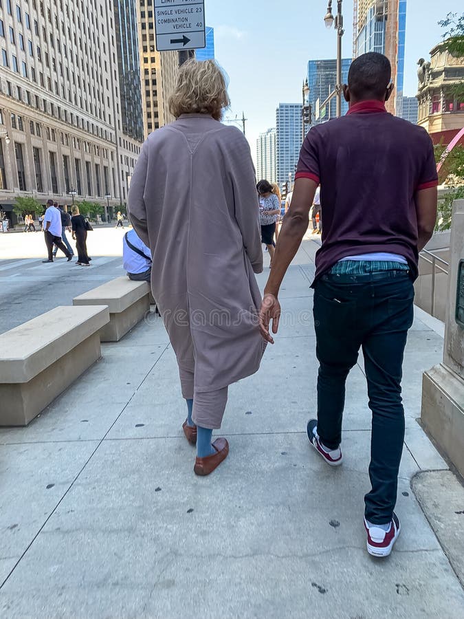 Two Men, Visual Opposites, Walk Down Wacker Drive in Downtown Chicago