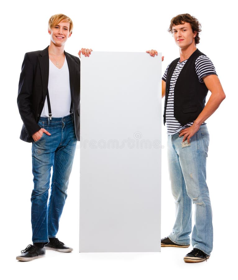 Two modern teenagers holding blank billboard royalty free stock image