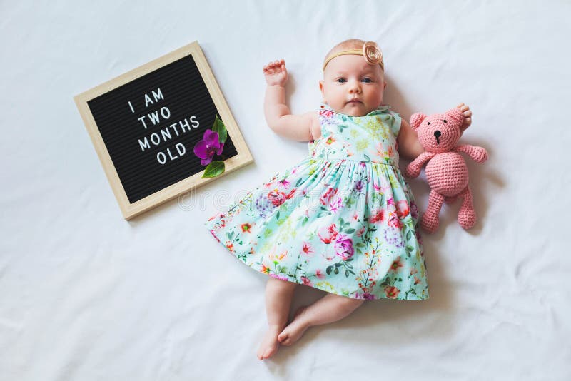 Cute One Month Old Baby Girl in Trendy Outfit Laying between Letter ...
