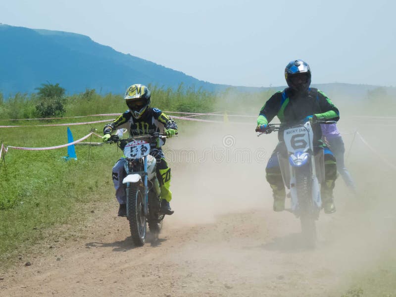 Motorcycle rider overtaking in motocross event. royalty free stock photos Motorcycle rider overtaking in motocross event. royalty free stock photos
