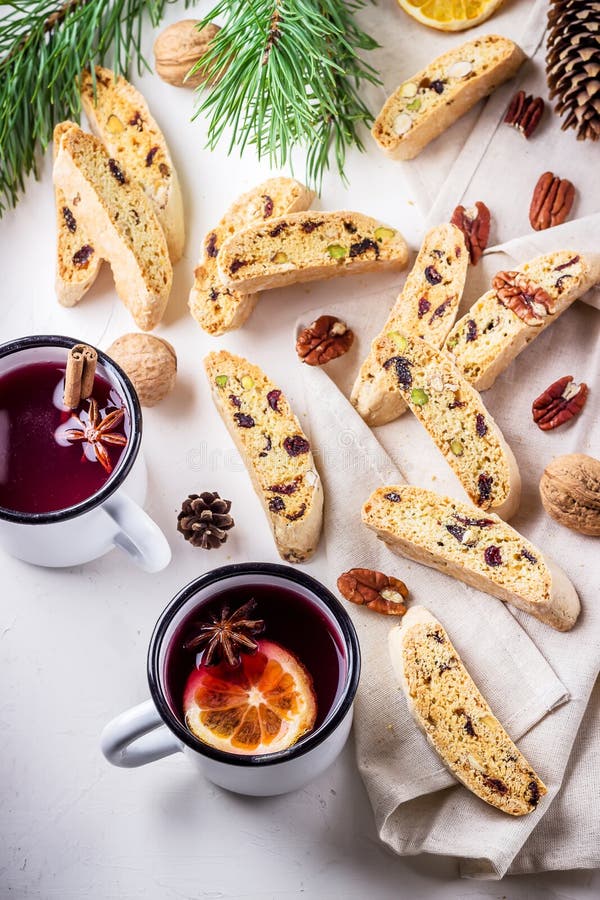 Two mugs of mulled wine and italian biscotti cookies on wooden table.Style rustic. stock photos Two mugs of mulled wine and italian biscotti cookies on wooden table.Style rustic. stock photos