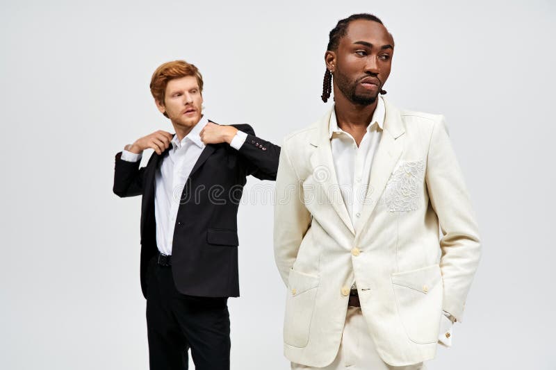 Two multicultural men in elegant suits stock photo