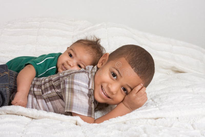 Two multiethnic boys brothers stock images