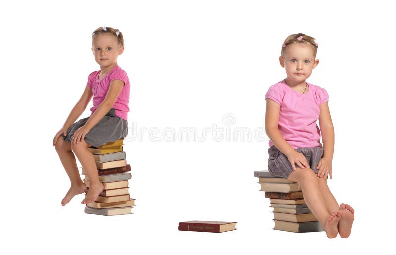 Two nice little girls sitting on stack of books