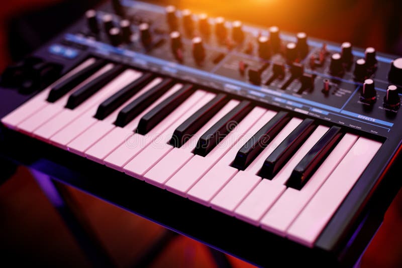 Closeup of Synthesizer Keyboard Illuminated by Pink and Blue Light