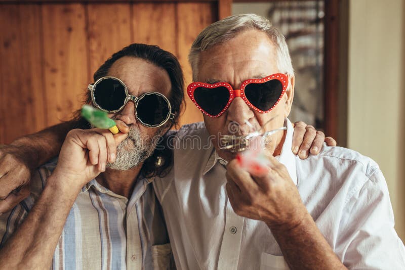 Two Old Friends with Party Blowers Stock Photo - Image of manhood,  friendship: 133600832