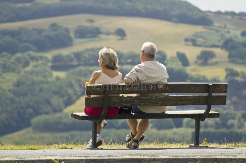 Two older people sitting on a bench