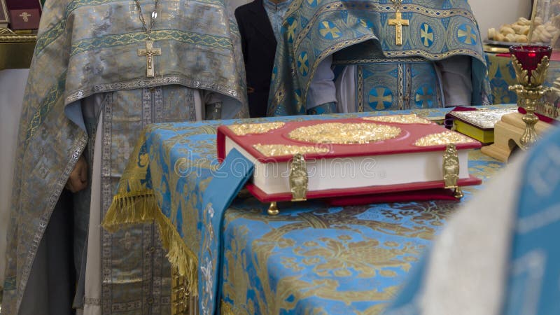 Bible in altar and priests