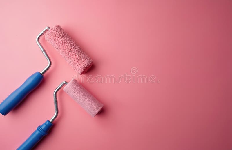 Two paint rollers, one large, one small, with blue handles, pink texture. On bright pink surface, offering copy space. Tools stock illustration