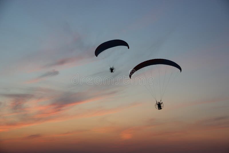 Two paragliders in the dramatic sky