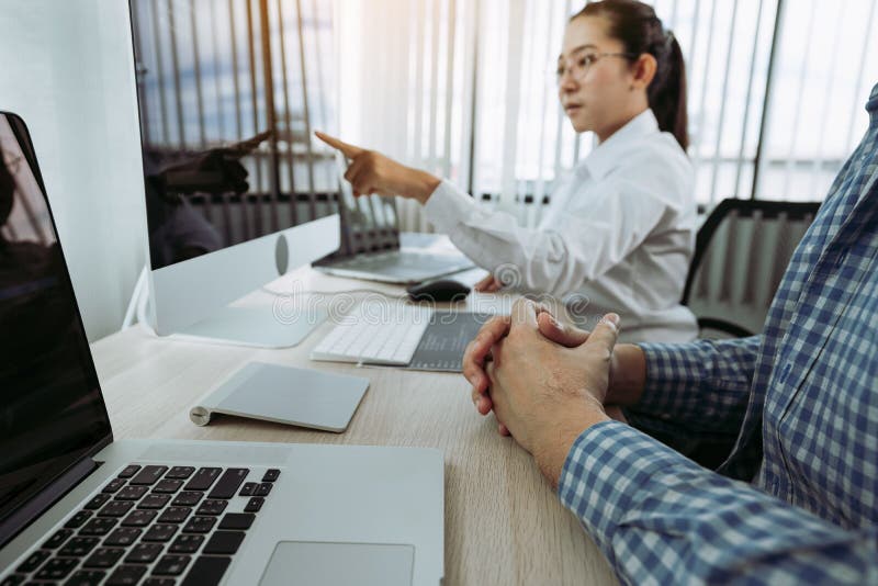Two partnerships developing programming and coding technologies working on laptop and analyzing together stock image