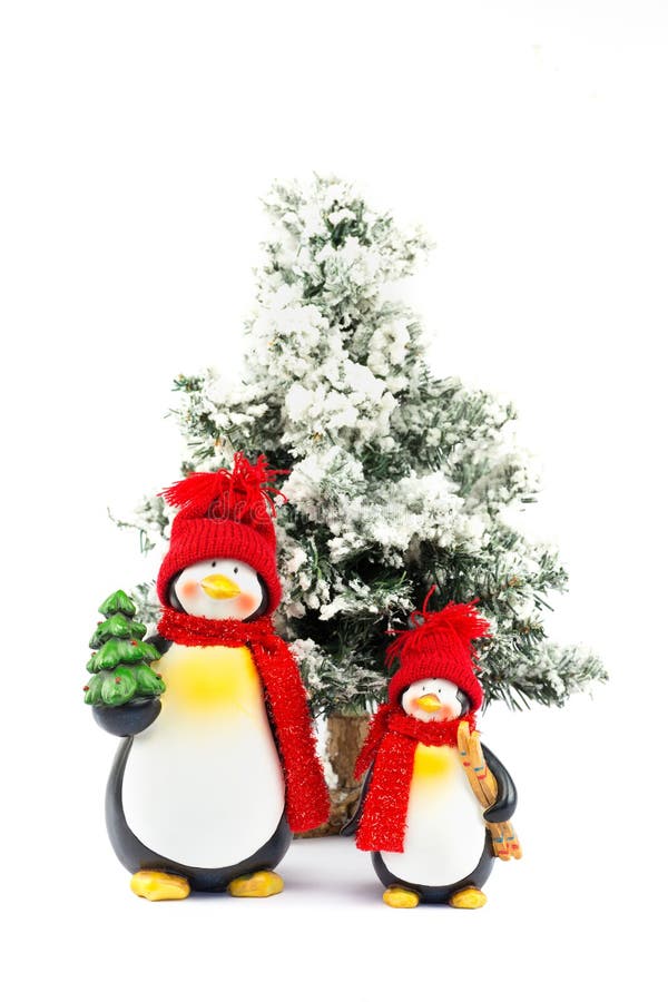 Two Penguin Figurines with Christmas Tree in Winter Stock Photo Image