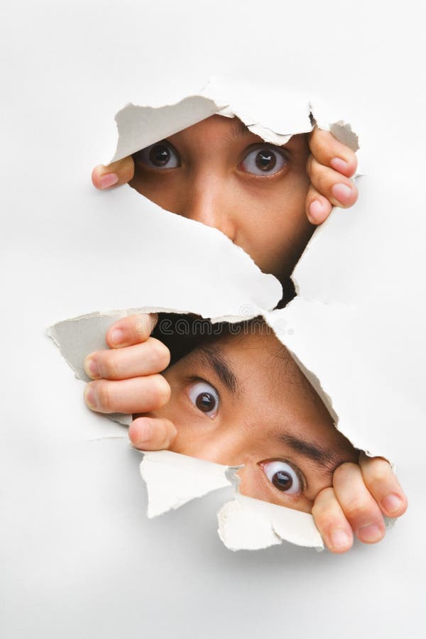 Two people peeking from hole in wall royalty free stock image Two people peeking from hole in wall royalty free stock image