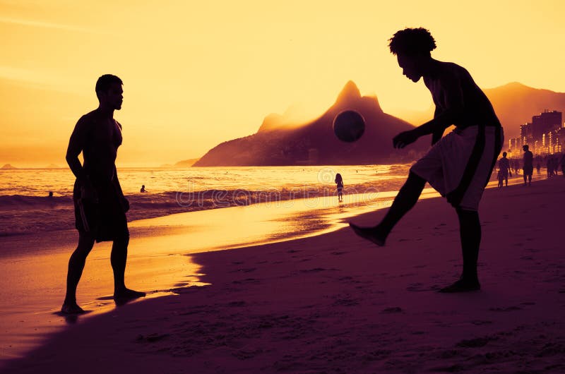 Two people playing soccer at beach at Rio at sunset royalty free stock photography Two people playing soccer at beach at Rio at sunset royalty free stock photography