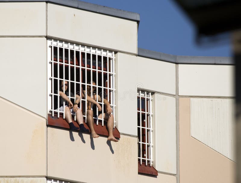 Two people in prison behind lattice