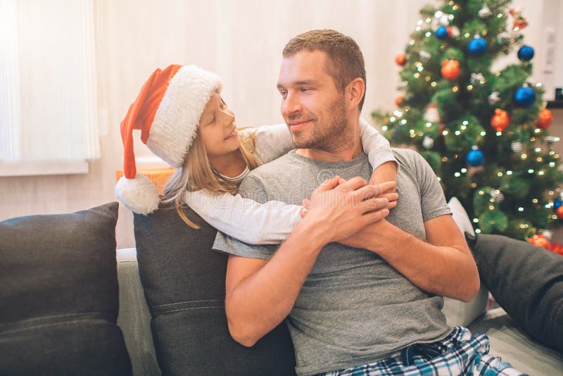 Two People Spending Time Together. Young Man Sits on Sofa and Looks ...