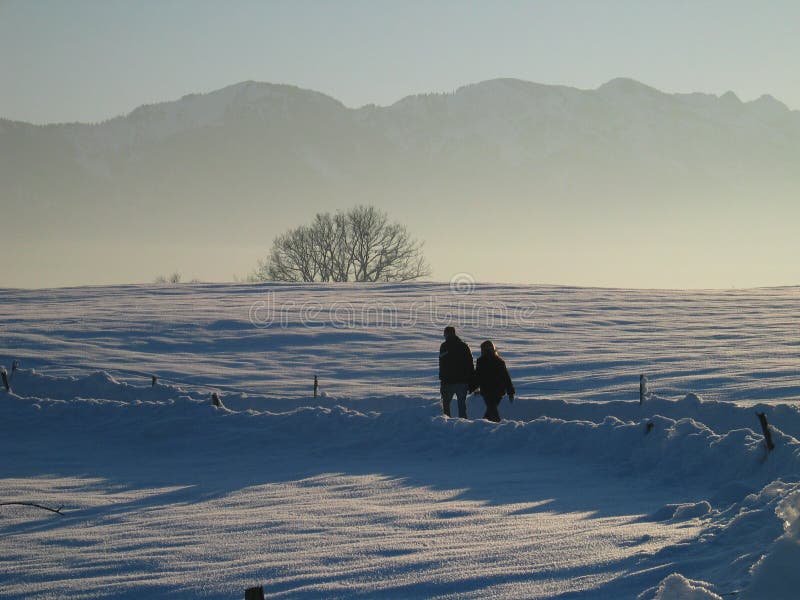 Two People Walking in Lonely Snow and Mountain Landscape