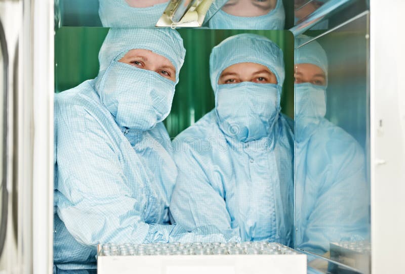 Two pharmaceutical factory workers royalty free stock images