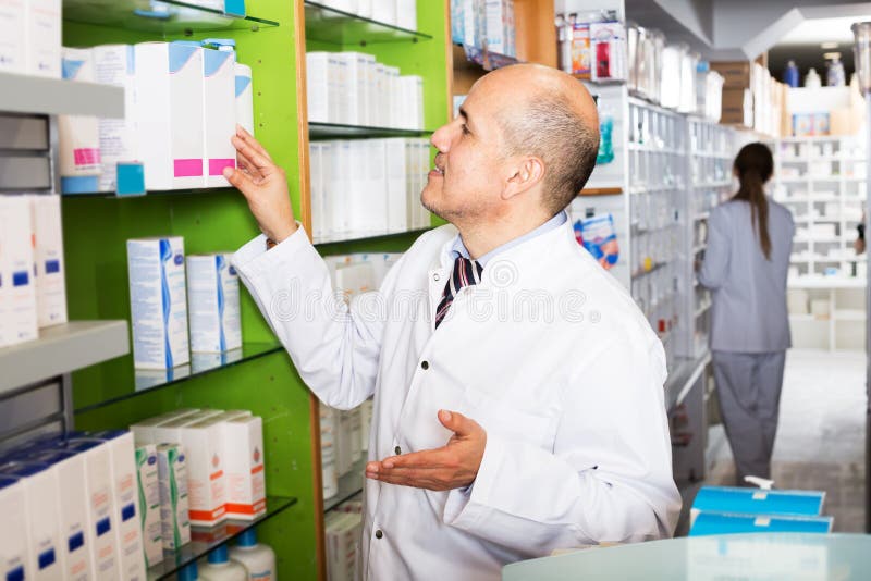 Friendly team of pharmaceutist and assistant working in chemist shop. Friendly team of pharmaceutist and assistant working in chemist shop