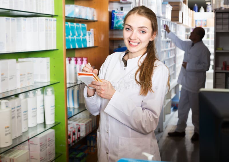Professional team of pharmaceutist and assistant working in chemist shop. Professional team of pharmaceutist and assistant working in chemist shop