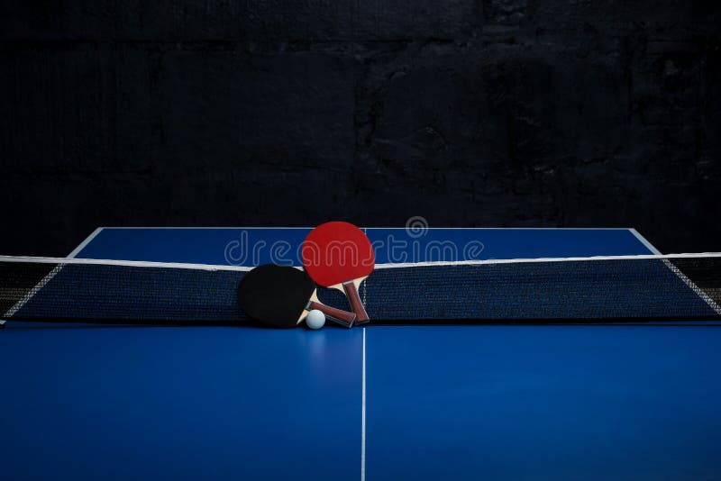 Two Ping Pong Rackets. Table Tennis Rackets and a Ball on a Blue Tennis