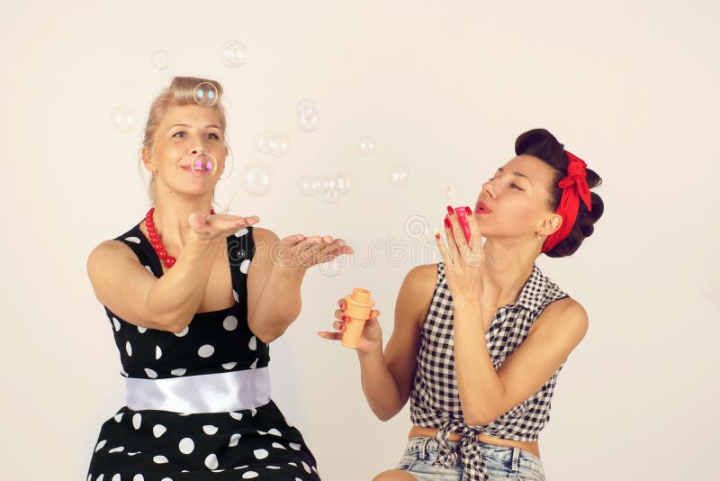 Two Pinup Girlfriends Playing with Soap Bubbles Stock Photo Image of