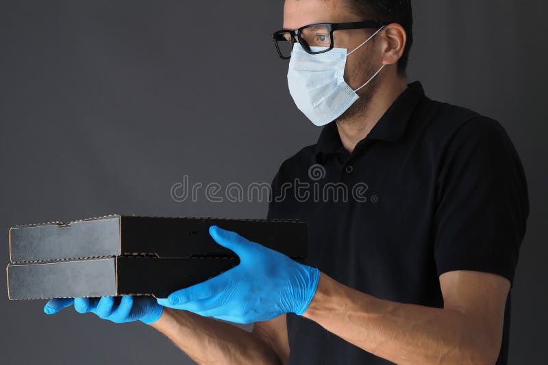 Delivery Man Wearing Protective Mask And Rubber Gloves Stock Photo