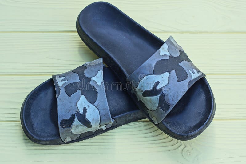Two plastic black gray summer slippers stock photos