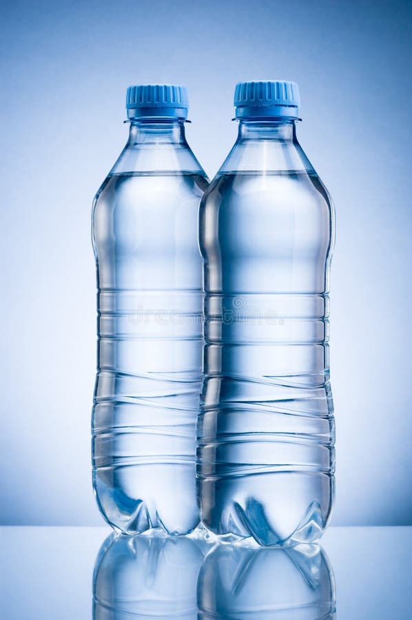 Two Plastic Bottle Of Drinking Water On Blue Background Stock Photo