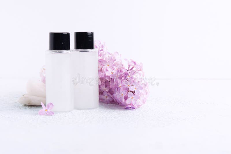 Two plastic bottle with shower gel or shampoo for bath with lilac aroma and natural flowers. Spa concept stock photo Two plastic bottle with shower gel or shampoo for bath with lilac aroma and natural flowers. Spa concept stock photo