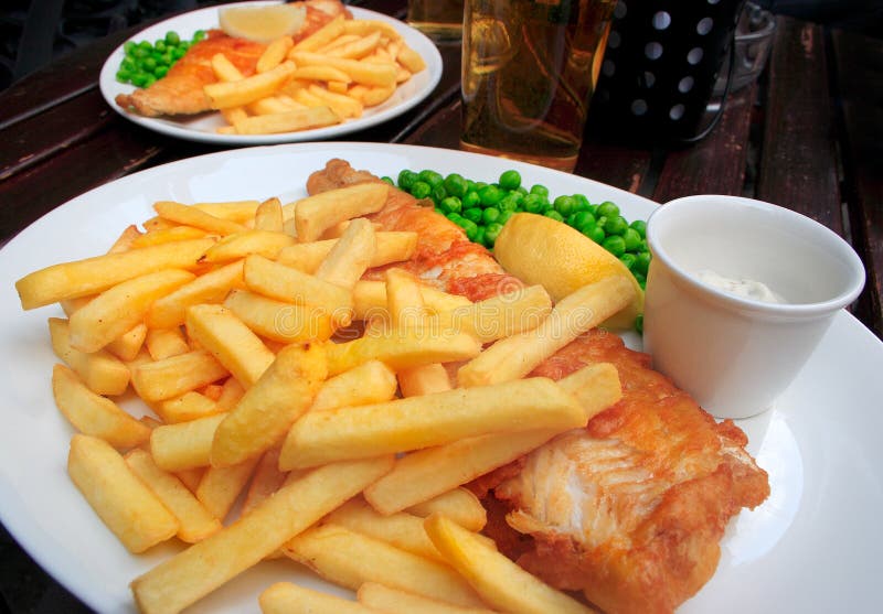 Two plates with fish and chips stock photography