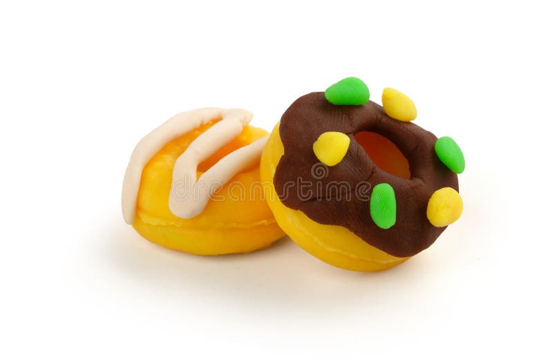 Two playdough donuts on the white royalty free stock photos