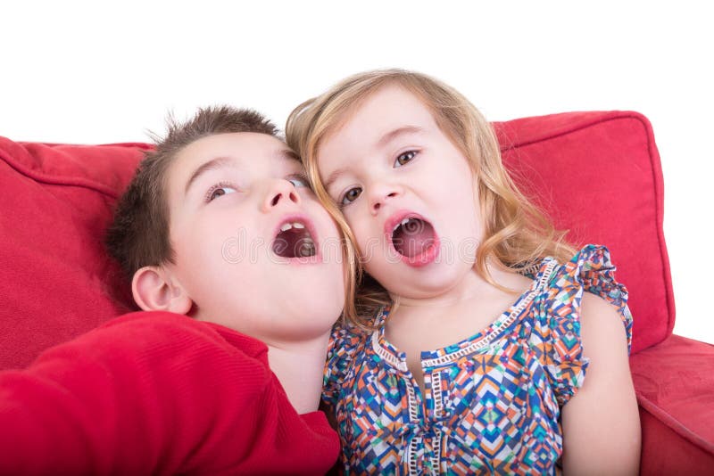 Two playful young children pulling faces