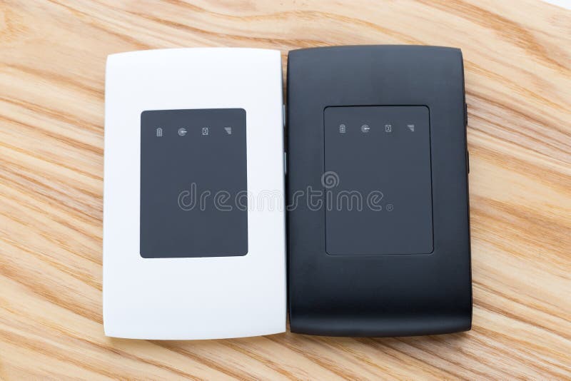 Two portable routers on the table. stock photos