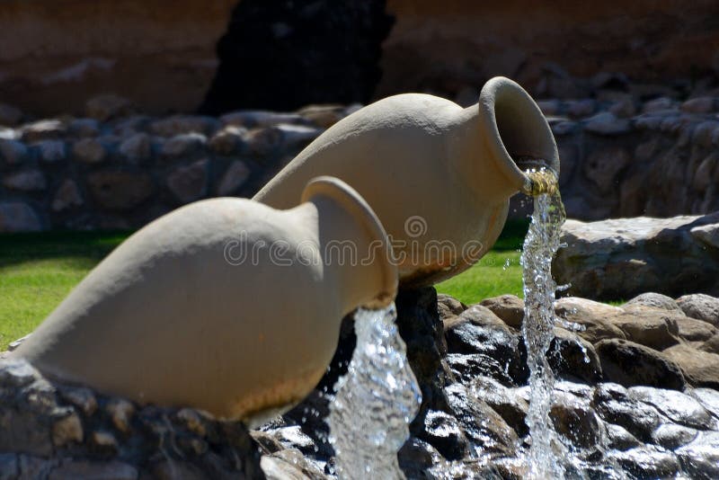 Two pottery fountain in an inner courtyard royalty free stock images