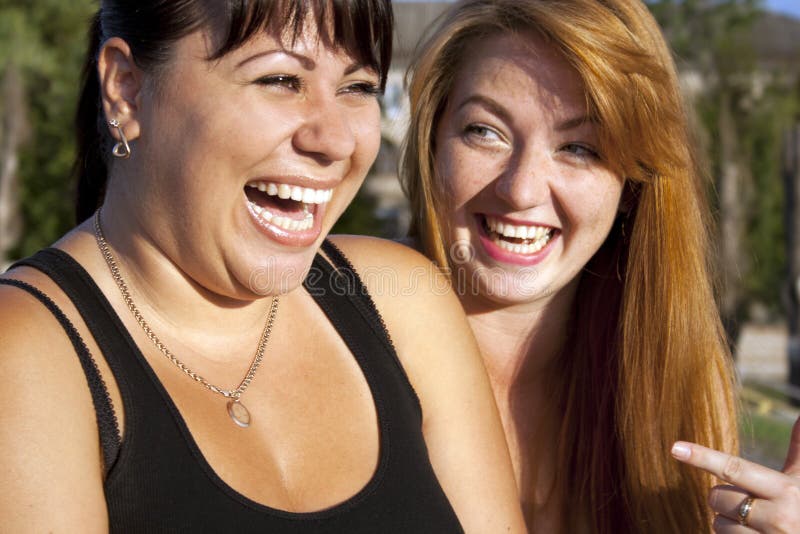 Two pretty adult girls laughing