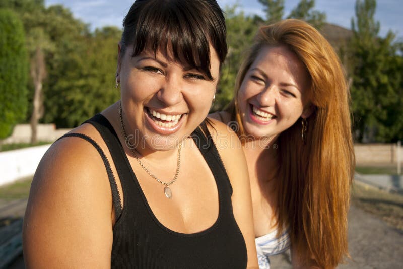 Two pretty adult girls laughing