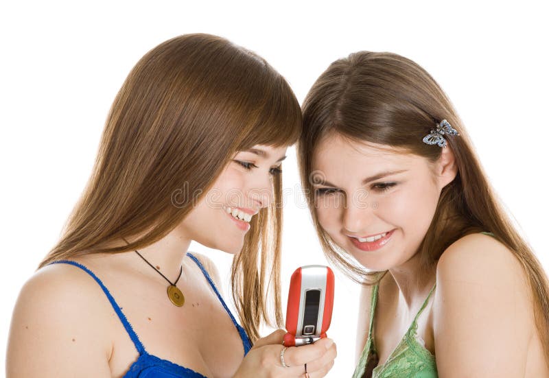 Two pretty girls reading SMS on mobile phone