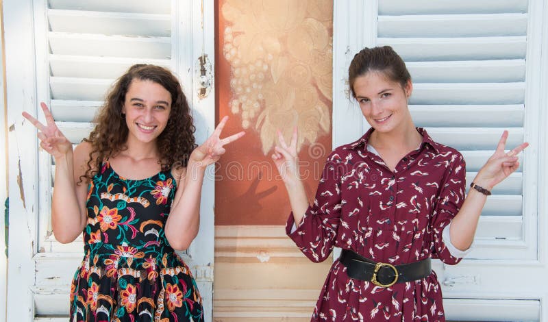 Two pretty girls are doing the peace sign. royalty free stock photography Two pretty girls are doing the peace sign. royalty free stock photography
