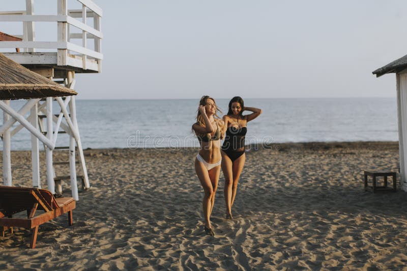 Young women having fun at summer vacations on the beach