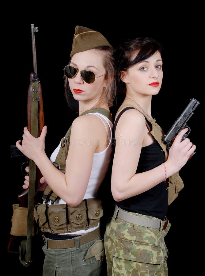 Two Pretty Young Women in Military Uniform with Guns Stock Image