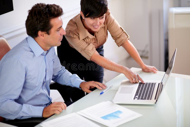 Two professional colleagues looking at computer