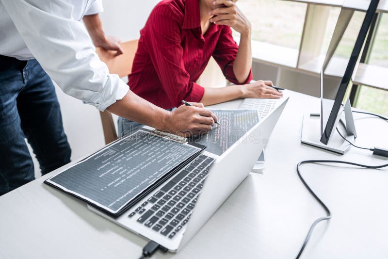 Two professional programmer cooperating and working on web site project in a software developing on desktop computer at company, codes and typing data code, Programming with HTML, PHP and javascript. Program coding working stock images, royalty-free photos and pictures